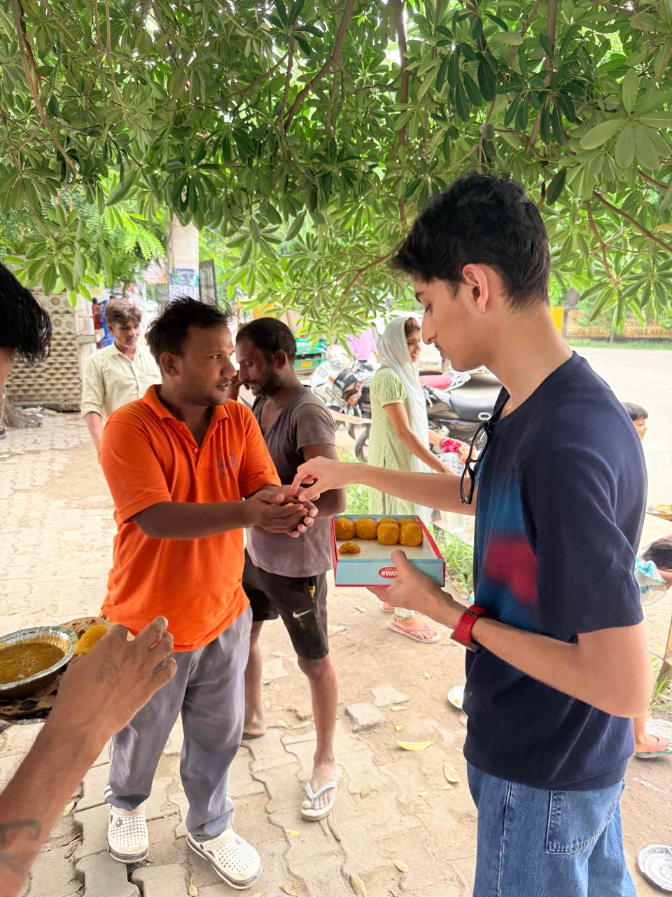 Jinanssh Jain handing out food during Nourish All on 4 August 2026 in Sector 14, Faridabad.