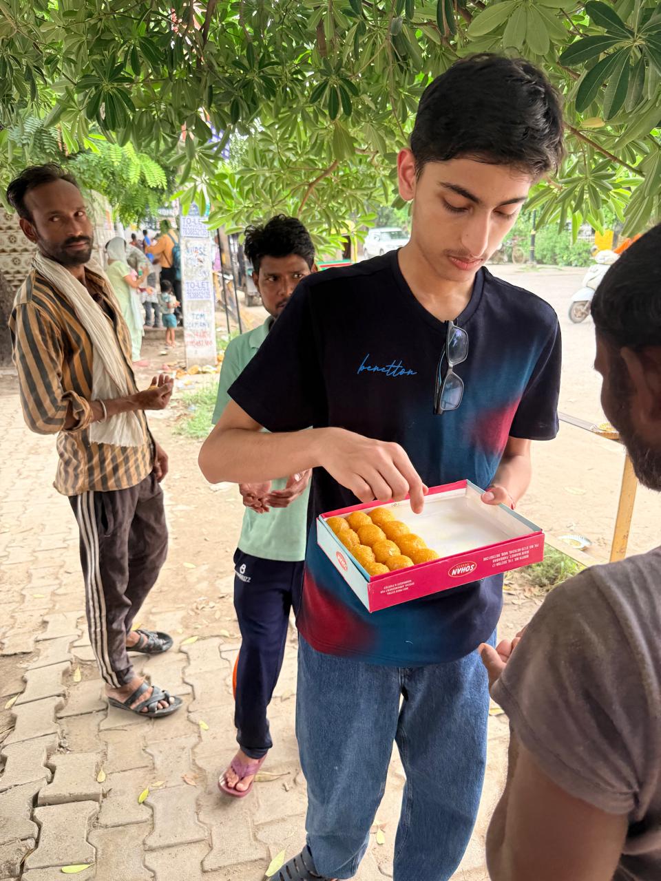 Jinanssh Jain holding a box of sweets during Nourish All on 4 August 2026.
