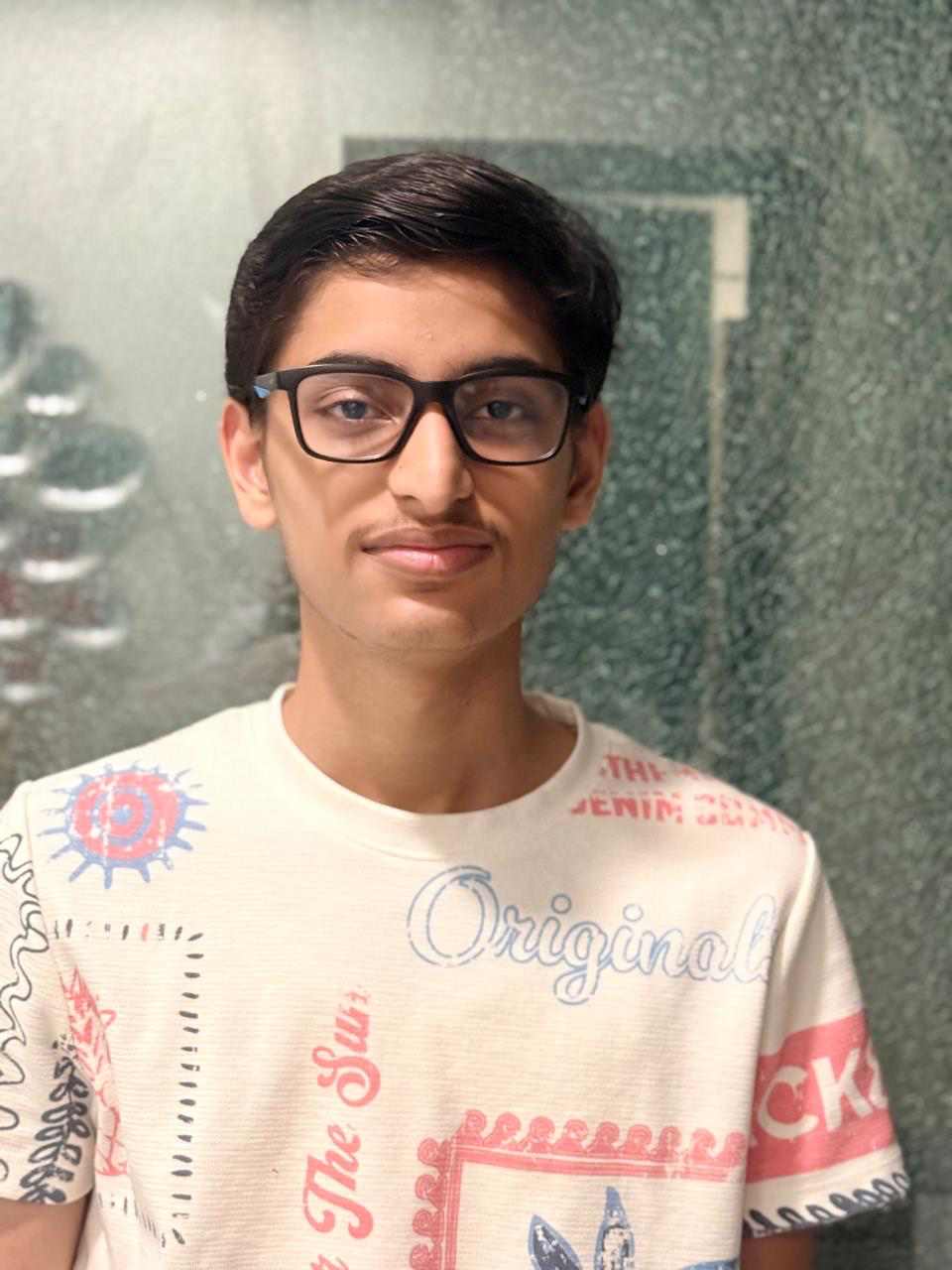Close-up portrait of Jinanssh Jain wearing glasses.